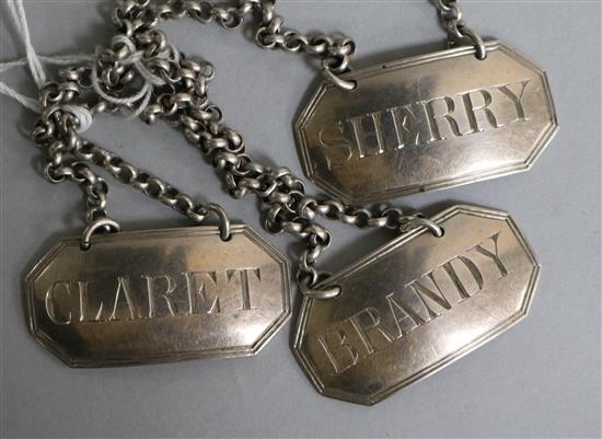 A set of three Victorian silver wine labels